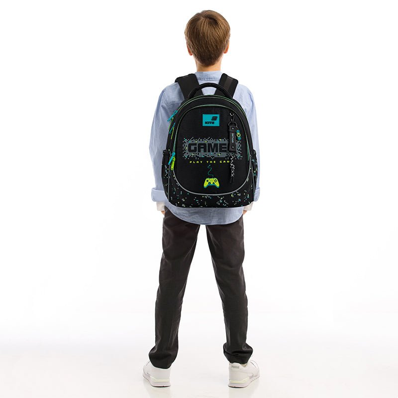 Dziecko z czarnym plecakiem Kite na plecach – system Ergo Kids.